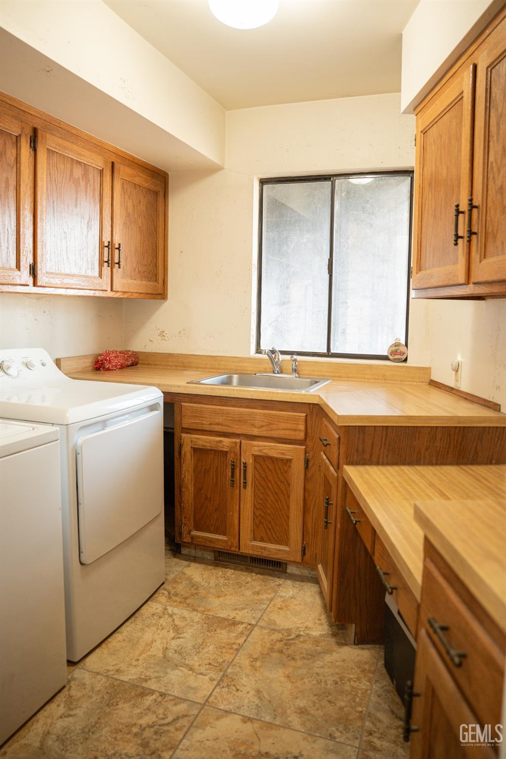 Undisclosed Address Bakersfield, CA 93308 - Photo 21 of 29 a utility room with a sink washer and dryer