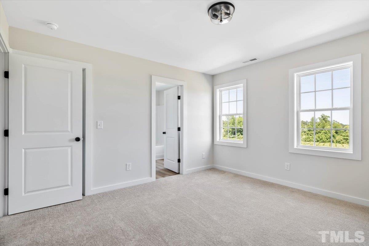 2075 Highway 55 Coats, NC 27521 - Photo 18 of 24 a view of an empty room with windows