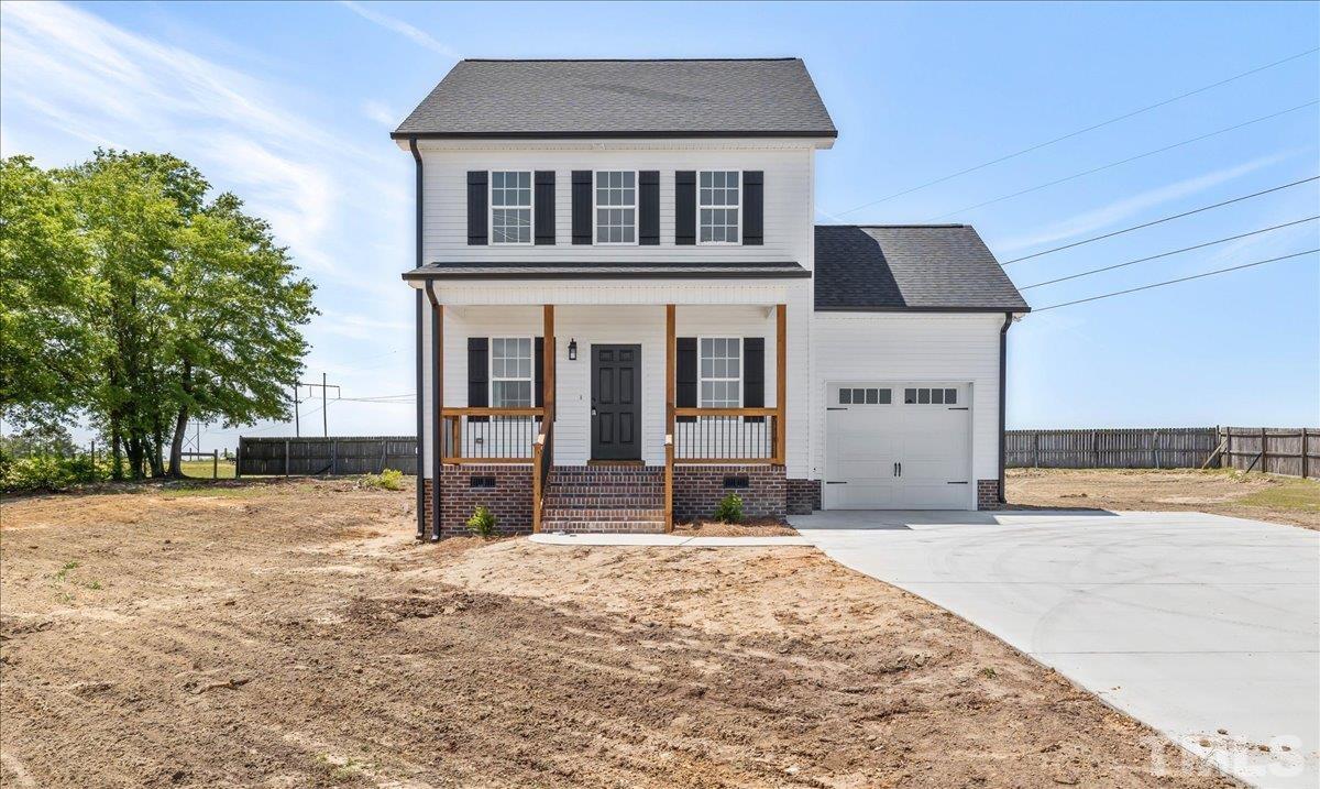 2075 Highway 55 Coats, NC 27521 - Photo 2 of 24 a front view of a house with a yard