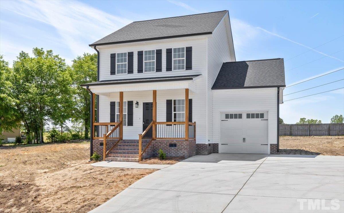 2075 Highway 55 Coats, NC 27521 - Photo 24 of 24 a front view of a house with garden