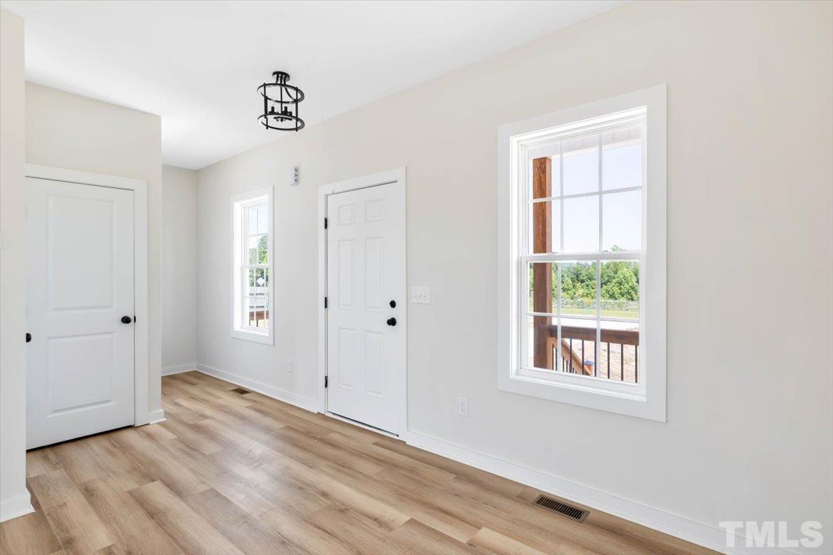 2075 Highway 55 Coats, NC 27521 - Photo 3 of 24 a view of an empty room with wooden floor and a window