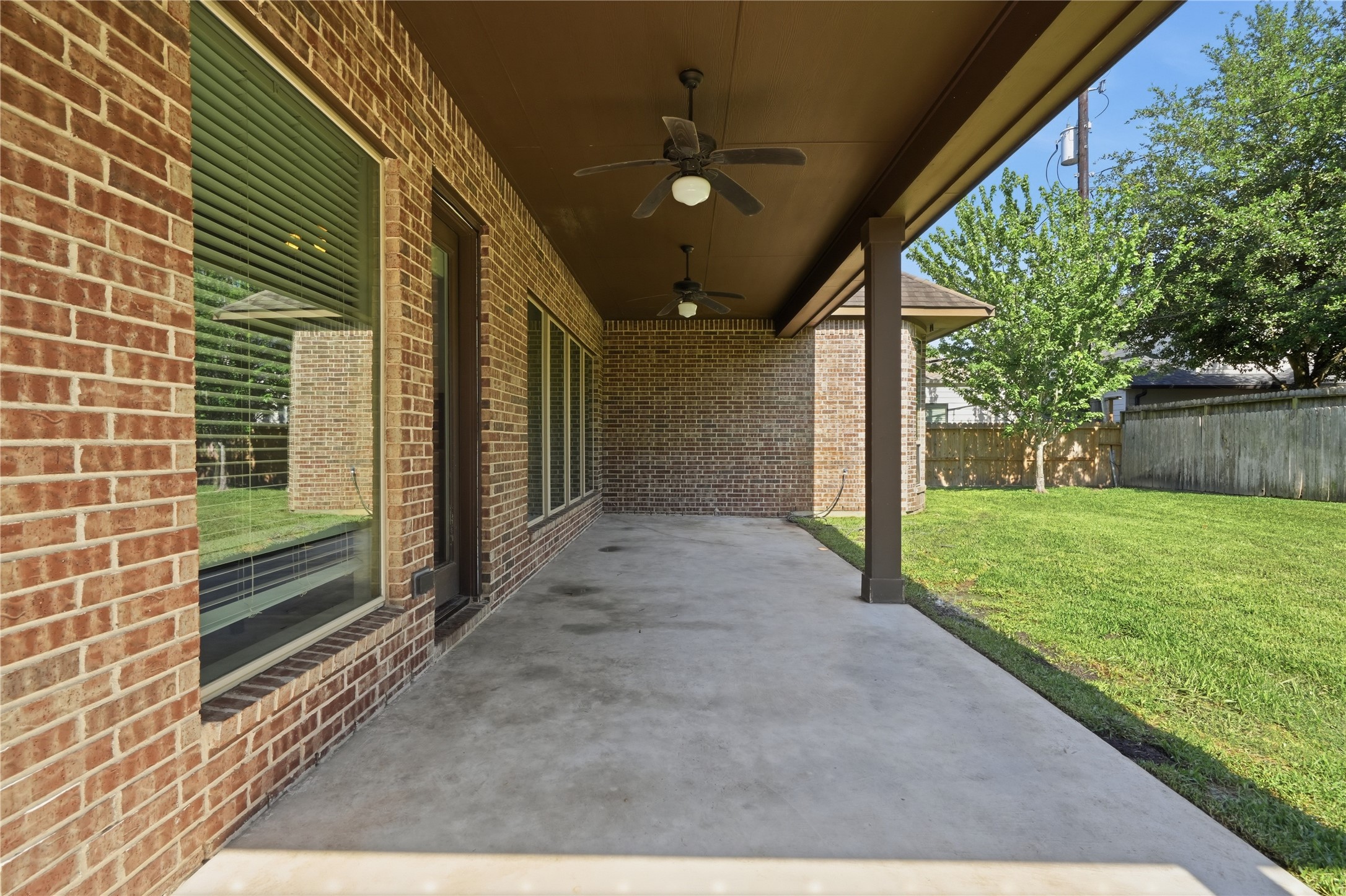 6429 Remlap Street Houston, TX 77055 - Photo 24 of 30 Covered backyard patio offering shade, airflow, and an ideal setup for gatherings and summer evenings.
