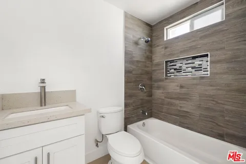 a bathroom with a toilet a sink and bathtub