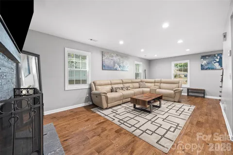 a living room with furniture rug and window
