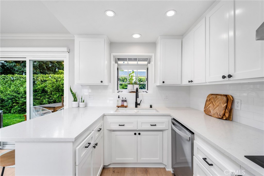 417 Gloucester Drive Costa Mesa, CA 92627 - Photo 2 of 29 a kitchen with a sink a window and cabinets