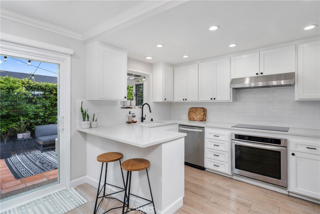 417 Gloucester Drive Costa Mesa, CA 92627 - Photo 9 of 29 a kitchen with stainless steel appliances granite countertop a stove a sink and a refrigerator