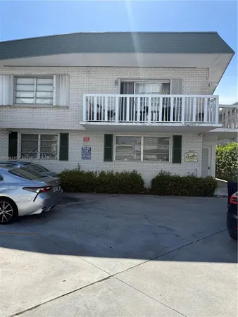 a view of a car park in front of house