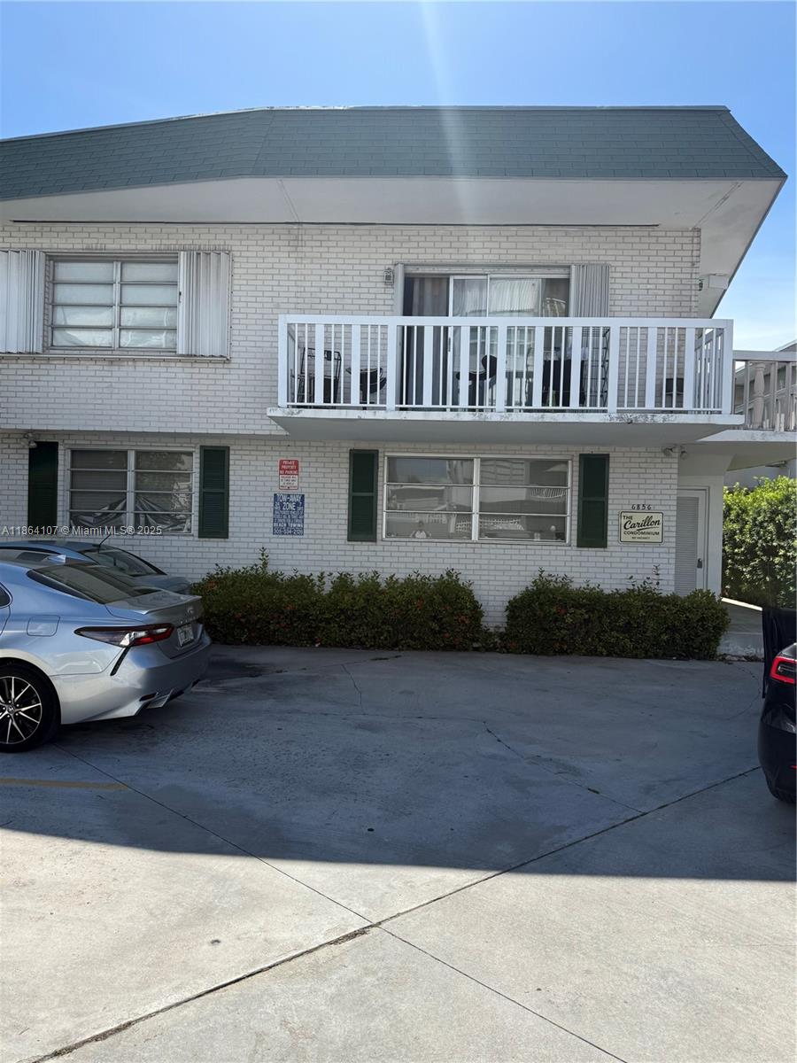 a view of a car parked in front of a house
