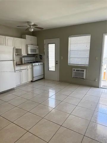 a kitchen with stainless steel appliances a refrigerator and a stove top oven