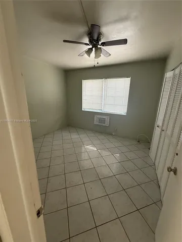 a view of an empty room and a window