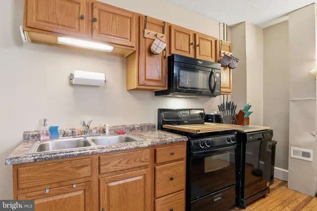 a kitchen with stainless steel appliances granite countertop a sink stove and microwave
