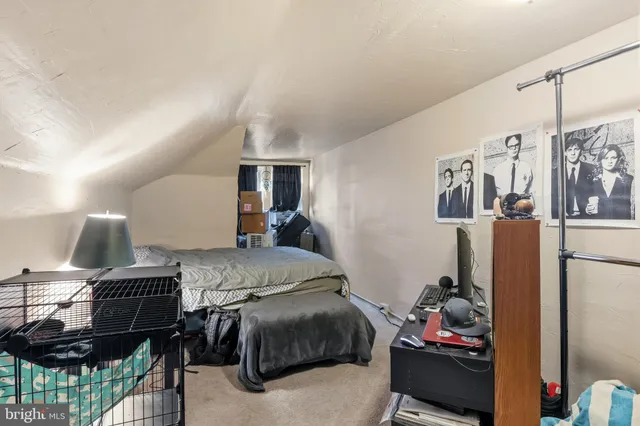 a bedroom with a bed closet and flat tv screen