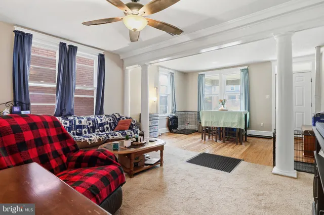 a living room with furniture and large windows