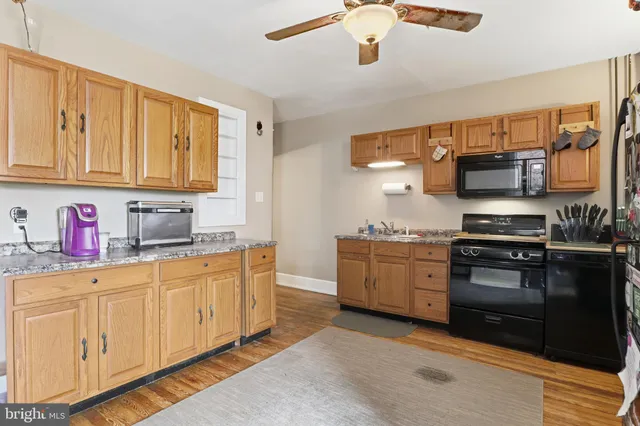 a kitchen with stainless steel appliances granite countertop a stove and cabinets