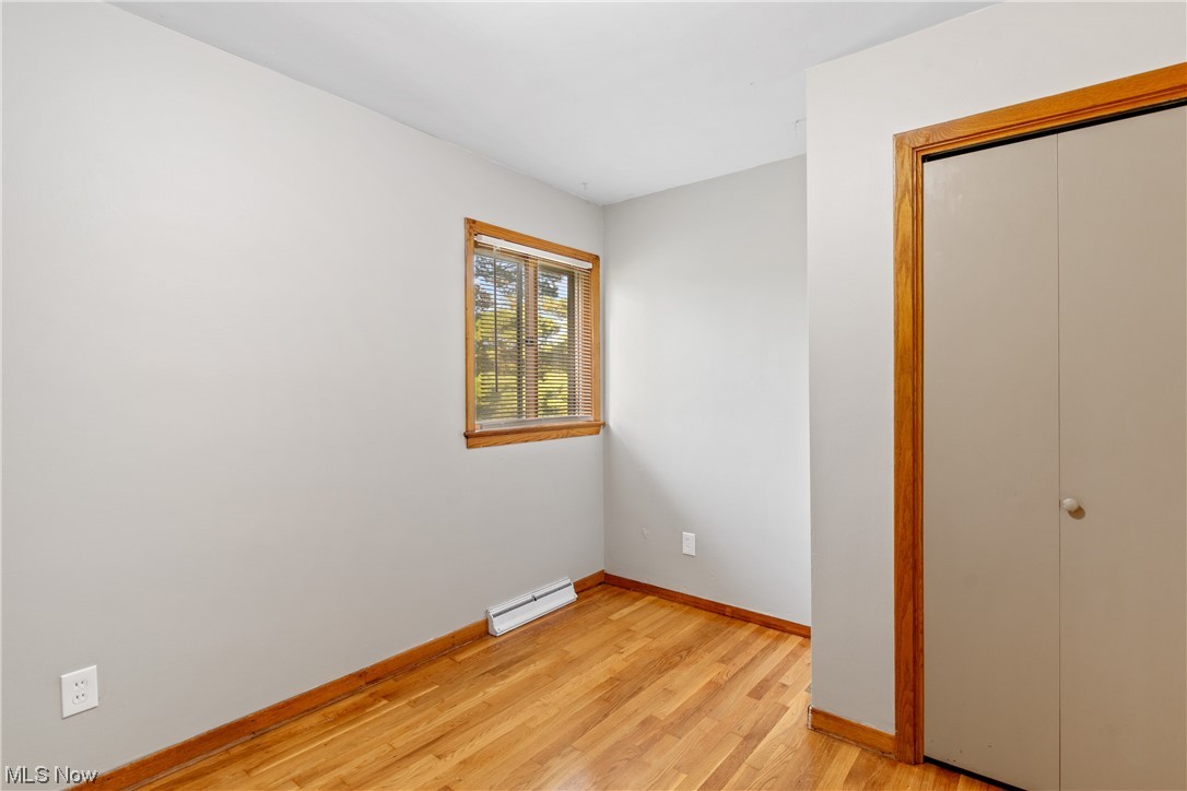 120 Lester Road New Franklin, OH 44319 - Photo 18 of 24 Bedroom with light hardwood flooring and baseboard heating