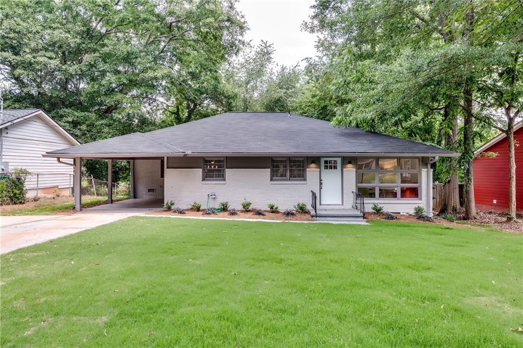 2330 Ousley Court Decatur, GA 30032 - Photo 1 of 1 a front view of a house with a garden and trees