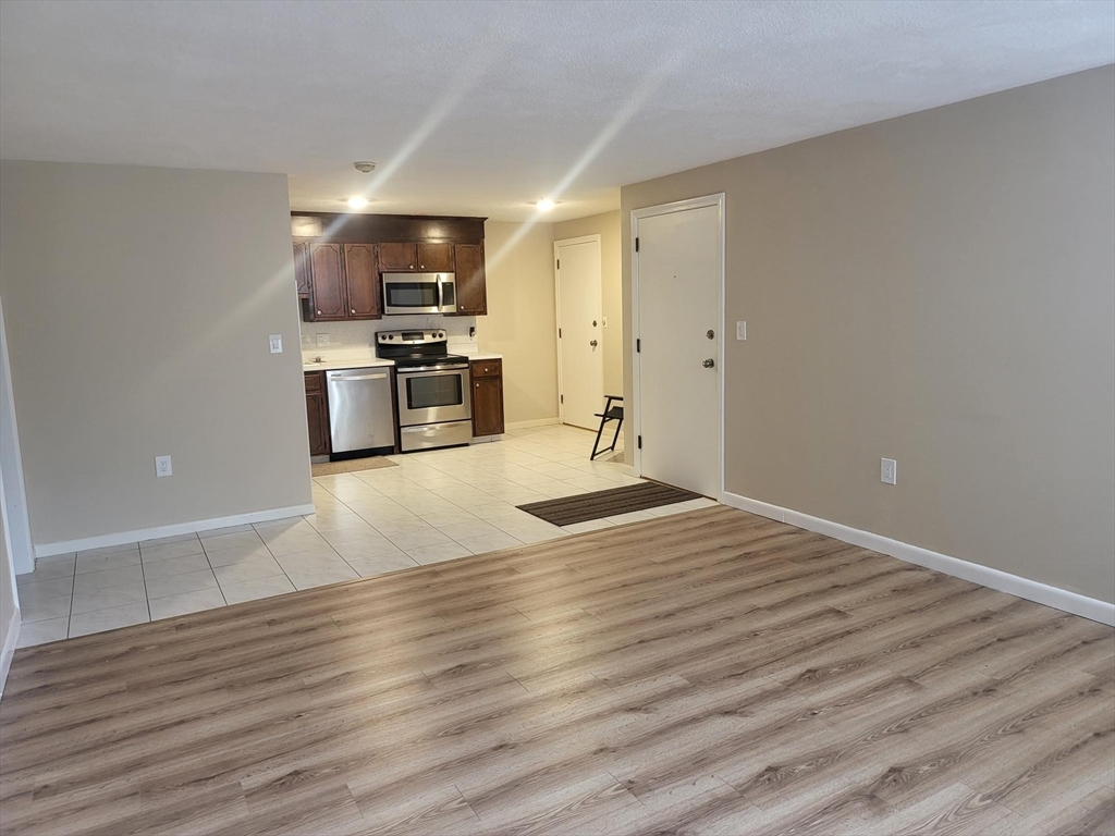 1 Hallmark Gardens, Unit 1 Burlington, MA 01803 - Photo 5 of 14 a view of kitchen with microwave and cabinets