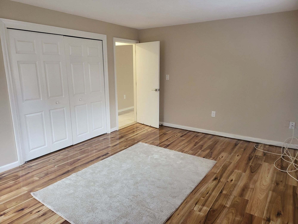 1 Hallmark Gardens, Unit 1 Burlington, MA 01803 - Photo 8 of 14 an empty room with wooden floor