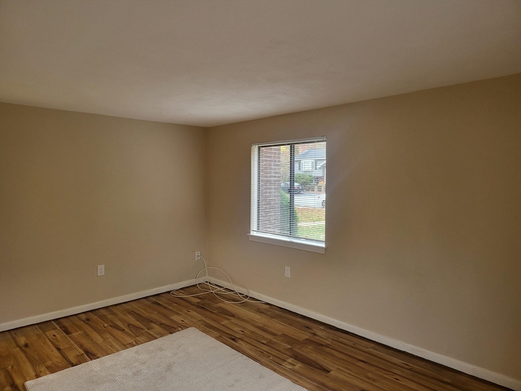 1 Hallmark Gardens, Unit 1 Burlington, MA 01803 - Photo 10 of 14 an empty room with wooden floor and windows