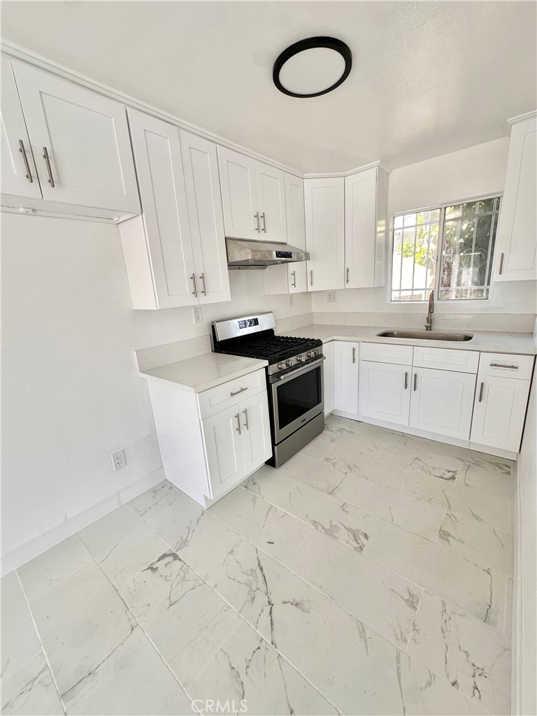 a large kitchen with cabinets and stainless steel appliances