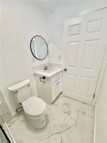 a white toilet sitting next to a bathroom sink