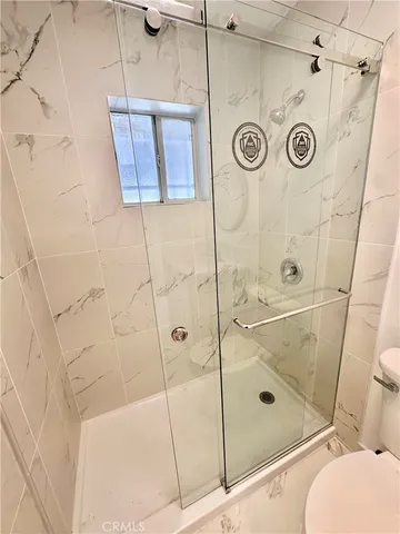 a bathroom with a shower and mirror