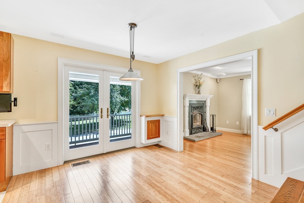 236 Gates Pond Road Berlin, MA 01503 - Photo 11 of 42 a view of a room with wooden floor a ceiling fan and windows