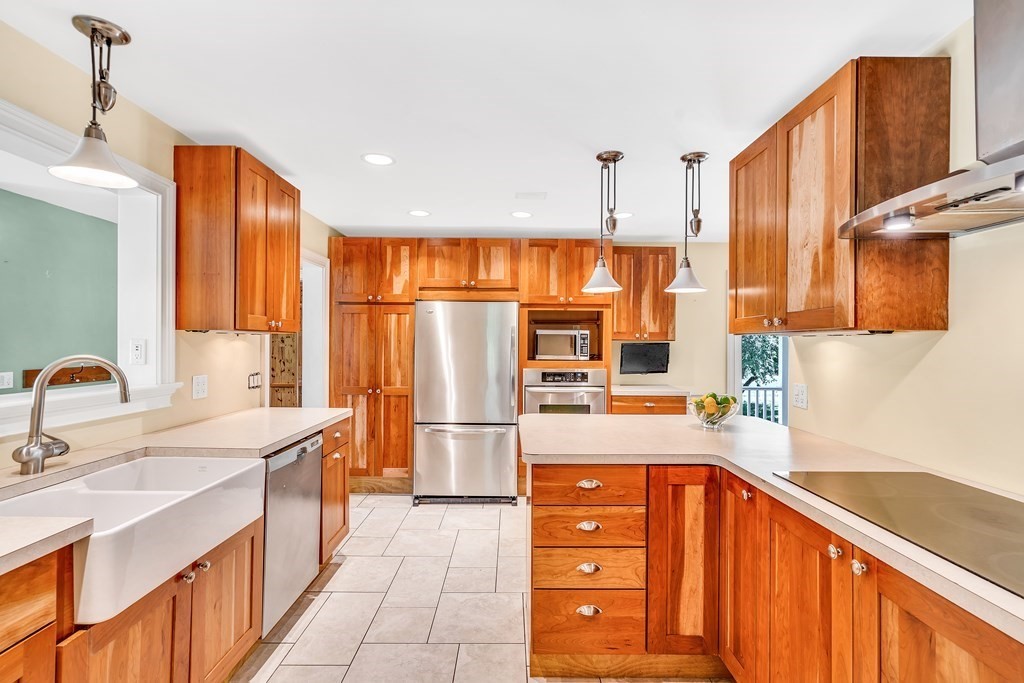 236 Gates Pond Road Berlin, MA 01503 - Photo 12 of 42 a kitchen with stainless steel appliances a sink cabinets and wooden floor