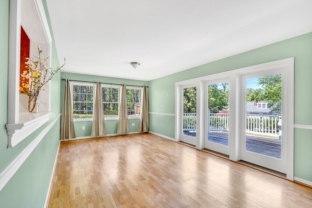 236 Gates Pond Road Berlin, MA 01503 - Photo 15 of 42 a view of an empty room with wooden floor and a window