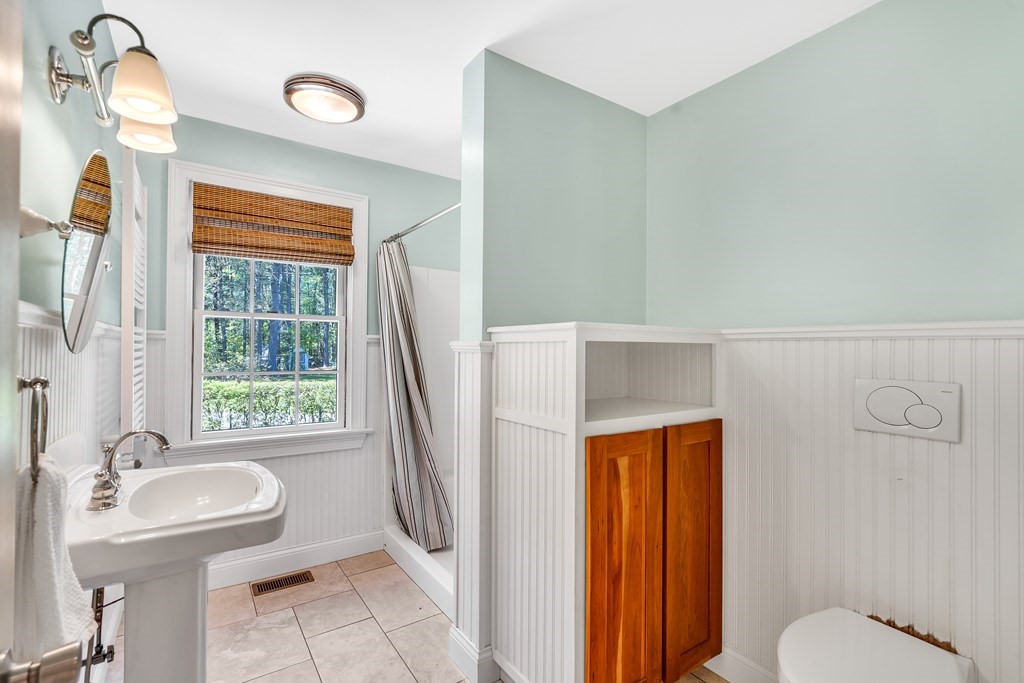 236 Gates Pond Road Berlin, MA 01503 - Photo 17 of 42 a bathroom with a sink a toilet and tub