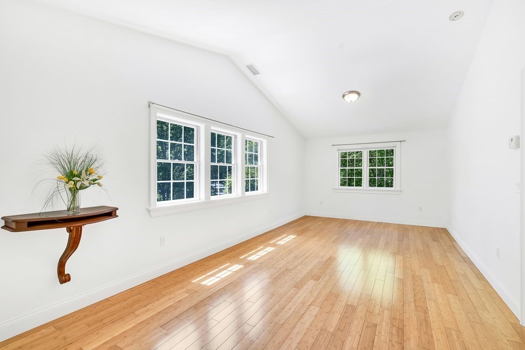 236 Gates Pond Road Berlin, MA 01503 - Photo 20 of 42 a view of an empty room with a window and wooden floor