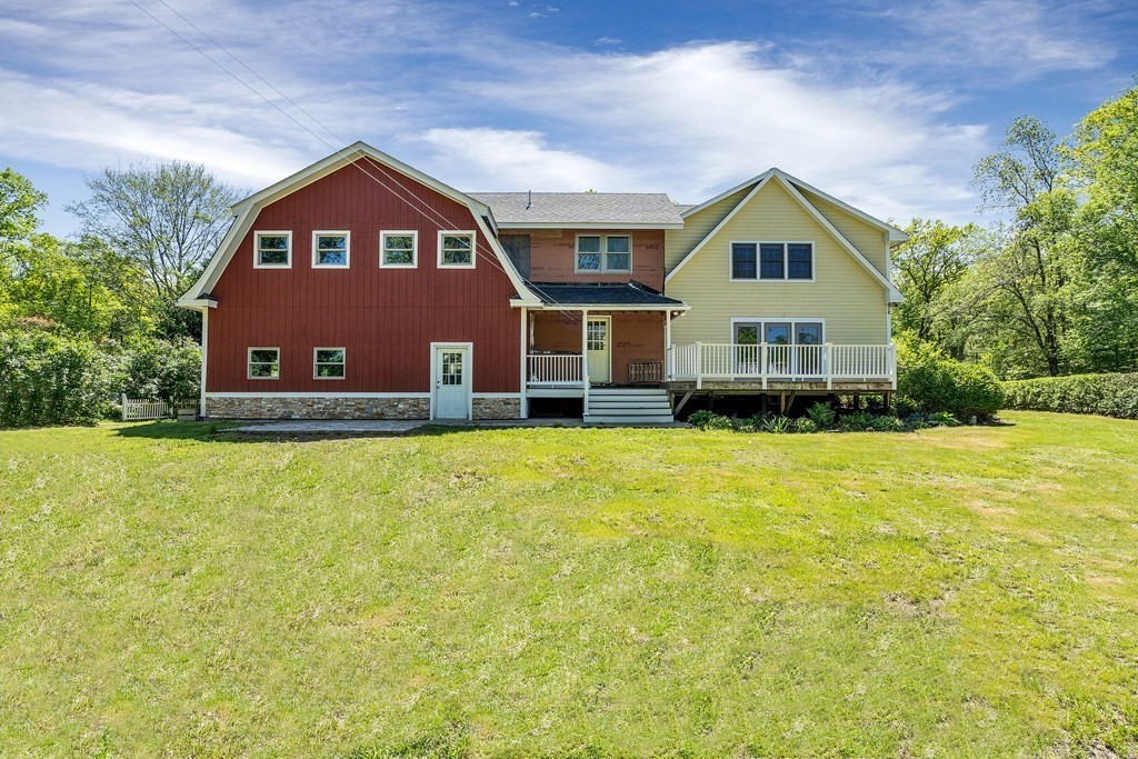 236 Gates Pond Road Berlin, MA 01503 - Photo 2 of 42 a front view of a house with a yard and swimming pool