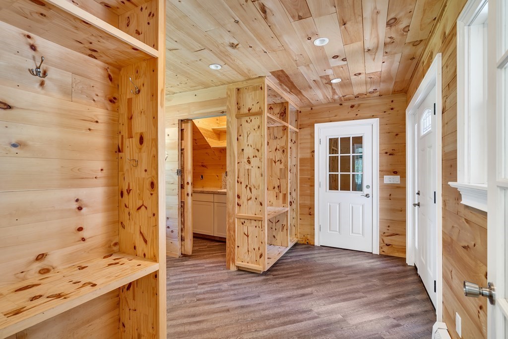 236 Gates Pond Road Berlin, MA 01503 - Photo 30 of 42 a view of a hallway with wooden floor and a living room