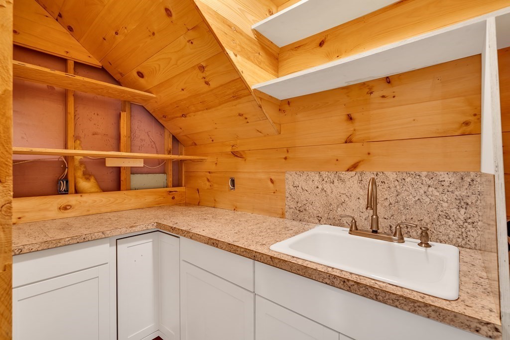 236 Gates Pond Road Berlin, MA 01503 - Photo 32 of 42 a bathroom with a granite countertop sink and white cabinets