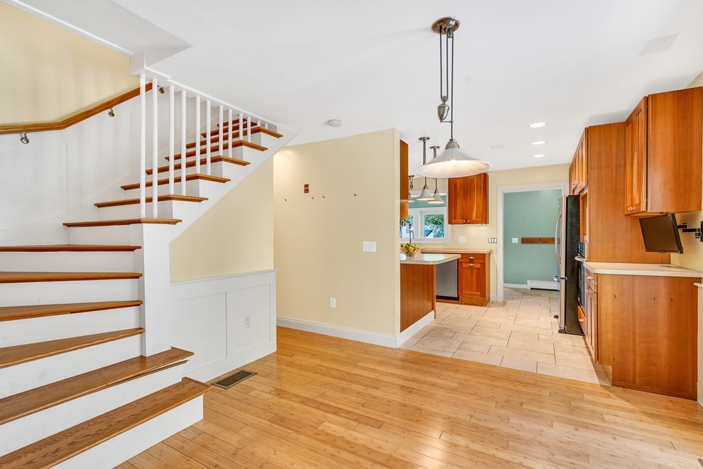 236 Gates Pond Road Berlin, MA 01503 - Photo 10 of 42 a view of a kitchen with wooden floor and staircase