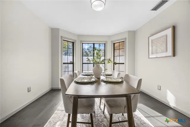 a view of a dining room with furniture and window
