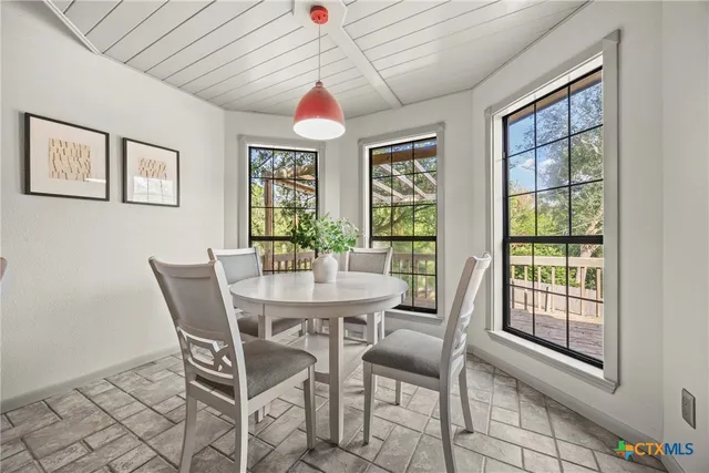 a view of a dining room with furniture wooden floor and chandelier
