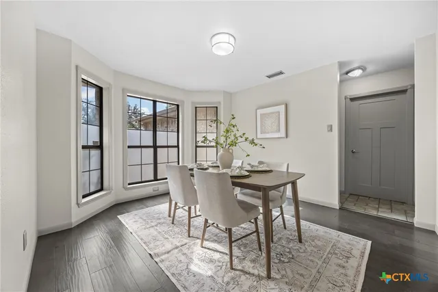 a view of a dining room with furniture and wooden floor