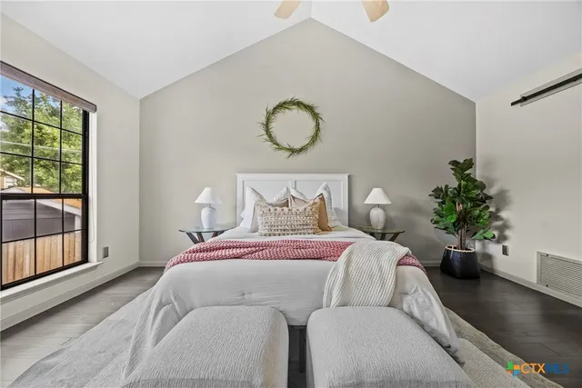 a bed sitting in a bedroom next to a window
