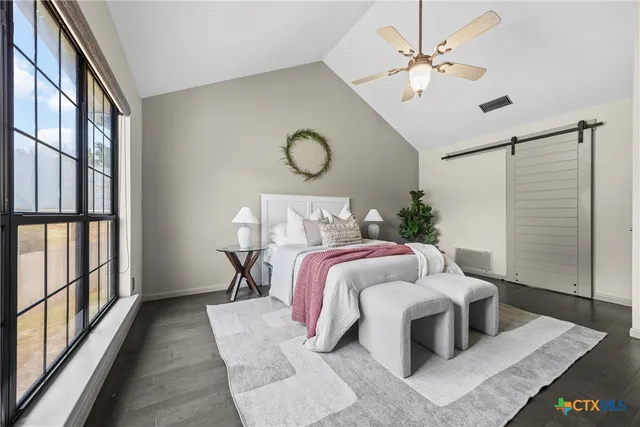 a bedroom with a bed and window