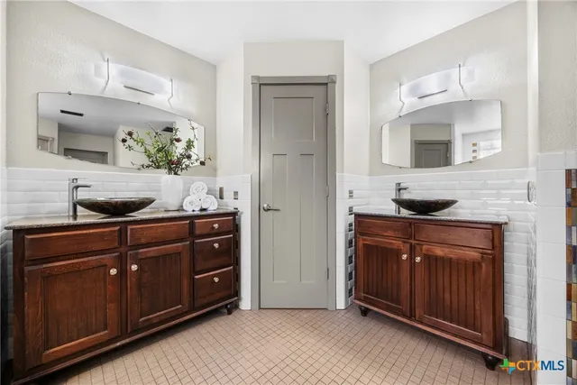 a spacious bathroom with a granite countertop sink and a mirror
