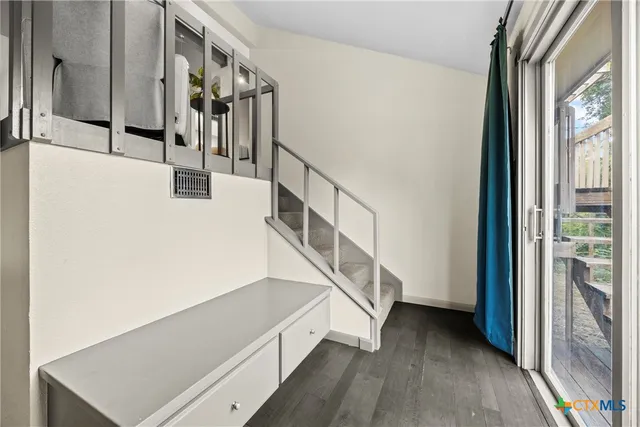 a view of entryway and hall with wooden floor