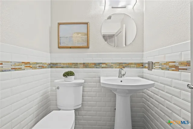 a bathroom with a sink a mirror and a toilet