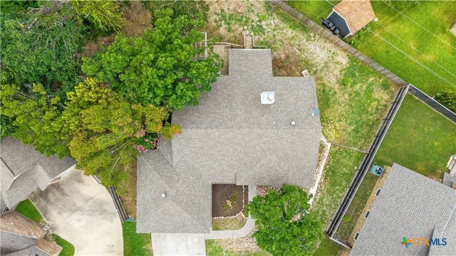 an aerial view of a house with a yard