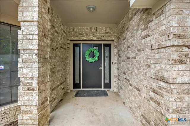 a view of entryway with brick walls