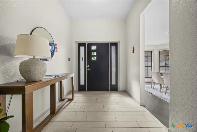 a view of entryway and hall with wooden floor
