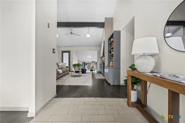 a living room with furniture and a mirror