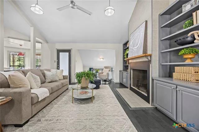 a living room with furniture and a fireplace
