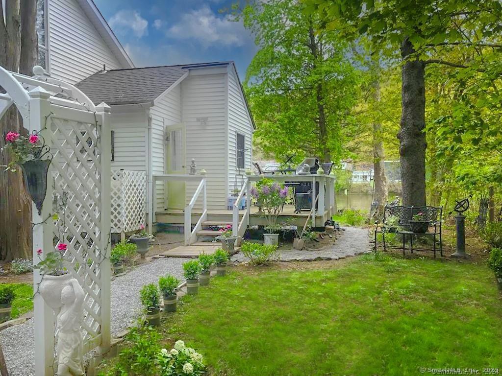 a view of a chair and table in backyard of the house