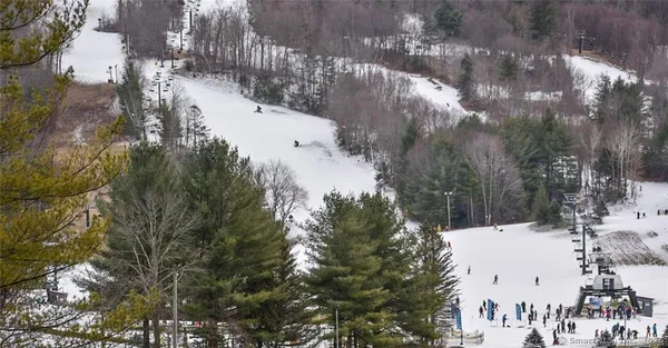 a view of yard covered with snow in front of house